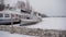 Close up of moored motor ships in winter season. Big boats on ice near embankment in wintertime.