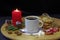 Close up of morning holiday breakfast. Homemade Christmas cookies, coffee and burning candles on wooden table.