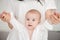 Close-up of mother and baby infant in white outfit