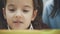 Close up mother becoming frustrated with daughter whilst doing homework sitting at the table at home in learning