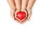 Close up of mother and children hands holding togheter red rubber heart