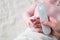 Close Up of mother hand taking temperature measurement of infant baby with high temperature by hi tech infrared digital