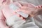 Close Up of mother hand taking temperature measurement of infant baby with high temperature by hi tech infrared digital