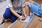 Close up on mother hand tie the child shoe. Mother helping her daughter tying the shoelace