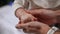 Close-up mother hands rubbing moisturizer in tiny palms of unrecognizable toddler. Caucasian woman taking care of infant