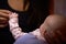 Close Up Of Mother Holding Newborn Baby\'s Hand