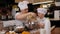 Close-up of a mother showing her son how to insert whisks into a mixer.