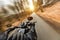 Close-up of motorbiker riding on empty road