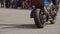 Close-up of a motorcycle and a motorcyclist during the performance of a cool Moto trick. Torsion of the motorcycle.