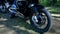 Close-up of a motorcycle wheel, forest background. Clip. Close-up of wheel trials motorcycle while competition in nature