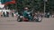 Close-up of a motorcyclist on a school tricycle. A motorcyclist performs stunts at the motor show.