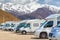 Close up motorhomes parked in a row on background snow mountain nature landscape