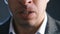 Close-up mouth of angry annoyed boss man screaming at camera. Businessman aggressively shouts experiencing stress at