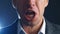 Close-up mouth of angry annoyed boss man screaming at camera. Businessman aggressively shouts experiencing stress at