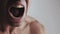 Close up mouth of Angry Man screaming at white background. Danger Violence