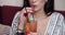 Close-up mouth of fashion female model drinking fresh cocktail using straw holding glass by hands