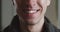 Close-up mouth of shocked young man is smiling, macro shot. Portrait of happy smile man.