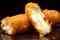 close-up of a mozzarella stick broken in half, melting cheese visible