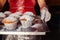 Close-up of muffins on a tray. Powdered sugar cakes. The work of the confectionery industry. Each cupcake is wrapped in paper