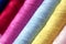 Close up multi color of the bobbins threads roll as background