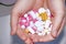 Close-up of multi-colored pills and capsules on the open palm of a painkiller pill