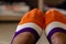 Close up of multi-colored socks on a black woman