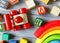 Close up Multicolored wooden cubes with letters, car, rainbow arc on gray background. Set of toys for studying alphabet. Education