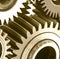 Close up of multiple brown cogs and gears on white background