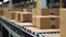 Close-up of multiple cardboard box packages moving along a conveyor belt in a warehouse