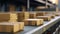 Close-up of multiple cardboard box packages moving along a conveyor belt in a warehouse