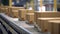 Close-up of multiple cardboard box packages moving along a conveyor belt in a warehouse