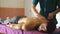 Close up of muscular sportsman lying on massage table and male hands of masseur massaging him shoulders in salon