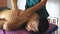 Close up of muscular sportsman lying on massage table and male hands of masseur massaging him shoulders in salon