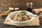 close up mushroom risotto white bowl with spoon napkin table. High quality beautiful photo concept