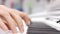 Close-up of a music performer`s hand playing the piano