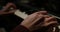 Close-up of a music performer`s hand playing the piano