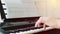 Close-up of a music performer`s man hand playing the piano from side