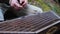 A close-up of a musician playing a string musical instrument, the cymbals, with hammers. Traditional musical instrument