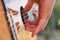 Close-up of the musician\'s playing hands. The guitarist plays the guitar. guitar outdoors