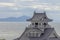 A close-up of Nagahama Castle from an elevated perspective, against the serene