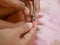 Close up of a nail clippers mother`s hand trimming her baby girl`s toenail