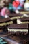 Close up of Nanaimo bars on a wooden board, ready for sharing.