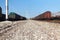 Close Up Narrow shot of a railway stones and rocks close to freight train at the Italian train depot in Bologna