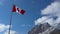 Close up of National Flag of Canada with natural mountains