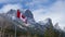 Close up of National Flag of Canada with natural mountains scenery