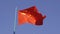 Close-up of the national flag of China waving in the wind on a clear day