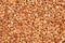 Close up natural stone carpet, coloured in different shades and tints of sandy brown and beige. Decorative stone coating. Slip