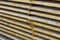 Close-up of neatly piled stack of natural brown rough wooden boa