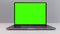 Close up of a new laptop computer with chroma key monitor. Action. Opened laptop with green screen isolated on white