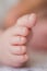 Close-up of a newborn baby`s toes.  Close-up of a newborn baby`s foot. The little leg of a white baby.  A tiny baby foot. Health